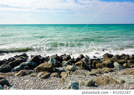 Sea coast covered with large stones. Russia. Sochi Sea coast covered with large stones. Russia. Sochi 65202287