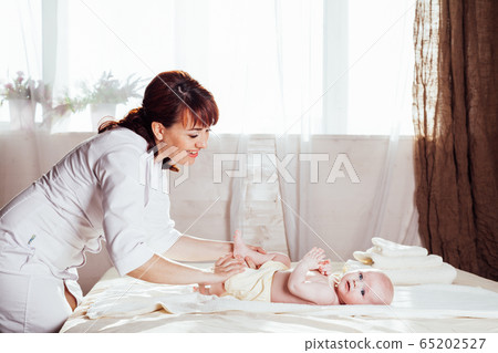the little boy baby mother doing massage hands and legs the little boy baby mother doing massage hands and legs 65202527