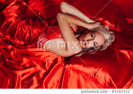sexy blonde in red underwear lies on a bed sexy blonde in red underwear lies on a bed 65202552