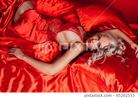 sexy blonde in red underwear lies on a bed sexy blonde in red underwear lies on a bed 65202553