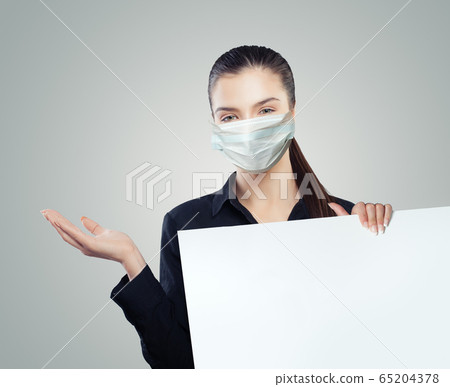 Businesswoman in protective mask holding empty Businesswoman in protective mask holding empty 65204378