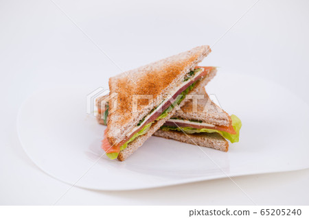 Ham sandwich on a plate on white background Ham sandwich on a plate on white background 65205240