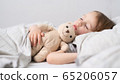 Baby girl sleeping with her teddy bear 65206057