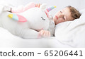 Baby girl sleeping with her unicorn. Close up. 65206441