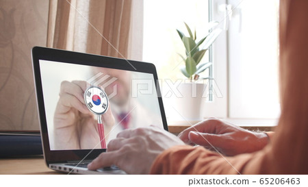 Doctor's advice on computer app, stethoscope with the South Korean flag. Telehealth technology in South Korea 65206463