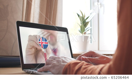 Doctor's advice on computer app, stethoscope with the Icelandic flag. Telehealth technology in Iceland 65206464
