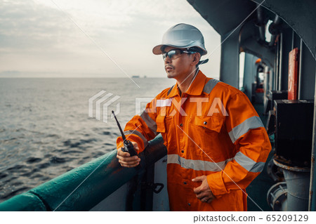 Filipino deck Officer on deck of vessel or ship , wearing PPE personal protective equipment Filipino deck Officer on deck of vessel or ship , wearing PPE personal protective equipment 65209129