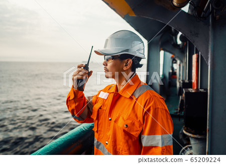 Filipino deck Officer on deck of vessel or ship , wearing PPE personal protective equipment Filipino deck Officer on deck of vessel or ship , wearing PPE personal protective equipment 65209224