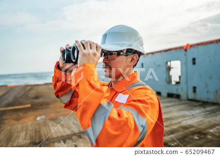 Filipino deck Officer on deck of vessel or ship , wearing PPE personal protective equipment 65209467