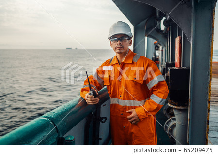 Filipino deck Officer on deck of vessel or ship , wearing PPE personal protective equipment 65209475