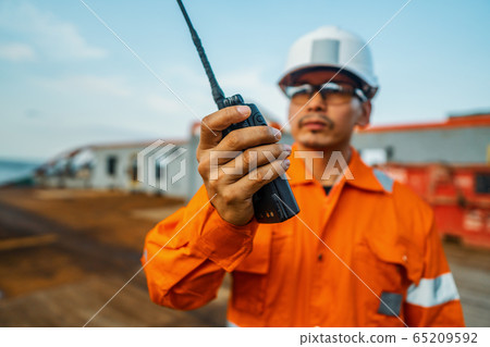 Filipino deck Officer on deck of vessel or ship , wearing PPE personal protective equipment Filipino deck Officer on deck of vessel or ship , wearing PPE personal protective equipment 65209592