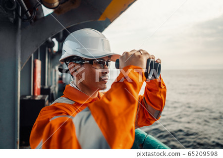 Filipino deck Officer on deck of vessel or ship , wearing PPE personal protective equipment 65209598