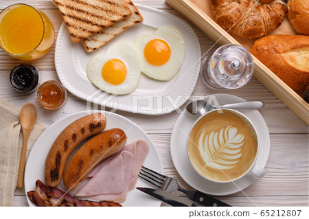 Cup of coffee latte with breakfast on wooden table 65212807