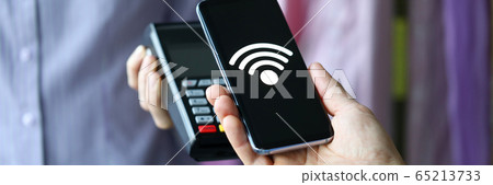 Female hand in dress market hold modern POS terminal Female hand in dress market hold modern POS terminal 65213733