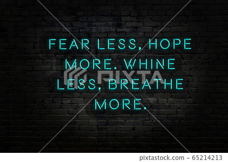 Wise quote. Neon inscription against brick wall Wise quote. Neon inscription against brick wall 65214213
