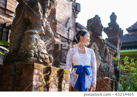 Japanese woman in traditional Balinese costume at a traditional temple in Bali 65214405