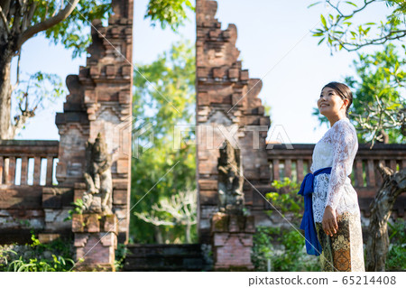 Japanese woman in traditional Balinese costume at a traditional temple in Bali Japanese woman in traditional Balinese costume at a traditional temple in Bali 65214408