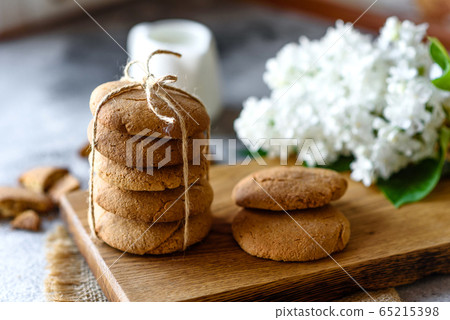 Homemade oatmeal cookies on a wooden cutting board Homemade oatmeal cookies on a wooden cutting board 65215398