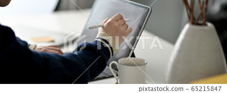 Cropped shot of female freelancer drawing on 65215847