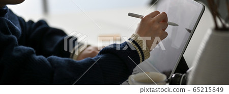 Side view of female freelancer drawing on digital Side view of female freelancer drawing on digital 65215849