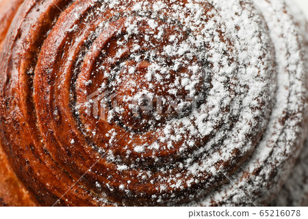 Cinnamon roll with powdered sugar on whole Cinnamon roll with powdered sugar on whole 65216078