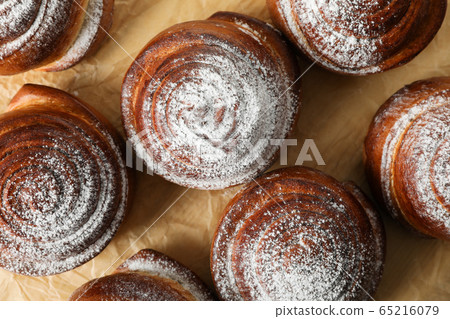 Cinnamon rolls on baking paper background, top Cinnamon rolls on baking paper background, top 65216079