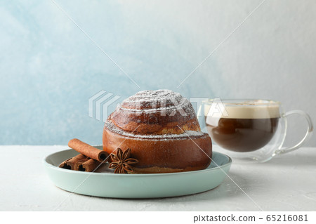 Cinnamon roll, anise and cup of cappuccino with Cinnamon roll, anise and cup of cappuccino with 65216081