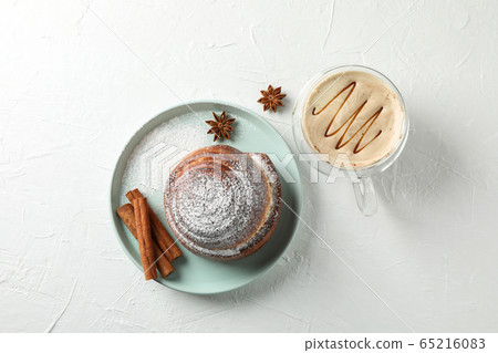 Tasty cinnamon roll with ingredients, cappuccino Tasty cinnamon roll with ingredients, cappuccino 65216083