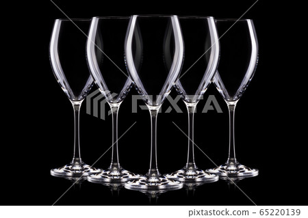 Set of empty glasses for white wine on black background. Set of empty glasses for white wine on black background. 65220139
