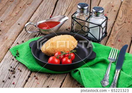 chicken Kiev with tomatoes on a plate chicken Kiev with tomatoes on a plate 65221323