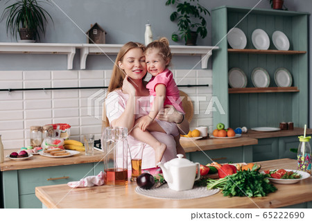 Happy beautiful mother with daughter in morning 65222690