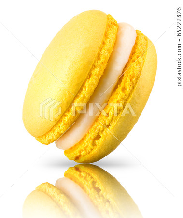 Macro photo of french yellow macaroon isolated on white background 65222876