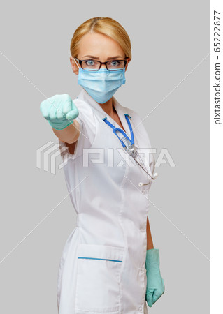 medical doctor nurse woman with stethoscope wearing protective mask medical doctor nurse woman with stethoscope wearing protective mask 65222877