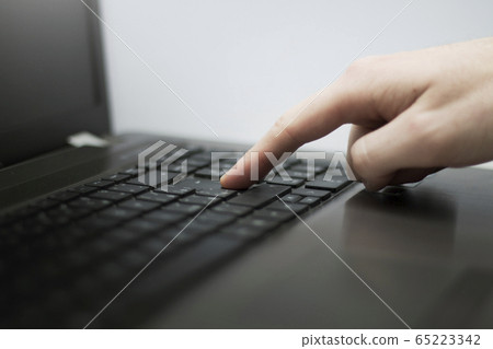 Close up photo of a man's finger pressing button 65223342