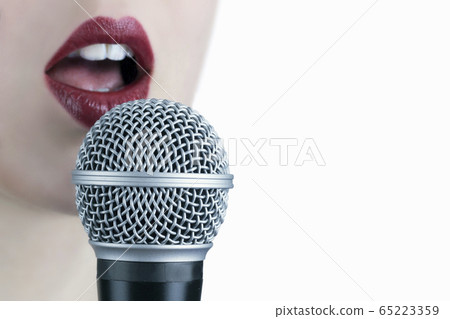 Close up of a young woman with red lips singing to 65223359
