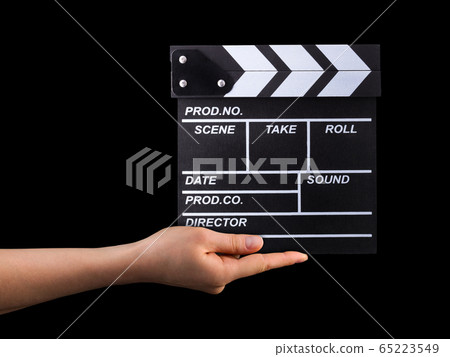 Human hand holding film clapper board isolated on black background Human hand holding film clapper board isolated on black background 65223549