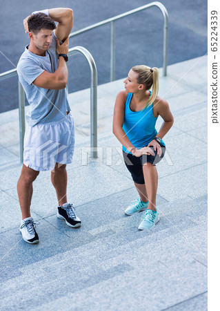 Young attractive couple exercising in stairs Young attractive couple exercising in stairs 65224339