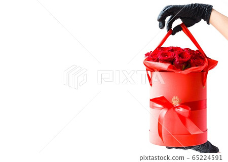 Hands in black medical gloves with red roses  Hands in black medical gloves with red roses  65224591