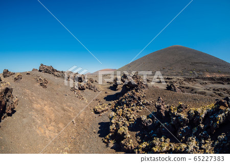 Volcanic landscape with stones and rocks at Lanzarote, Spain. 65227383