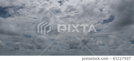Sky with gray cumulus clouds. Wide photo . 65227507
