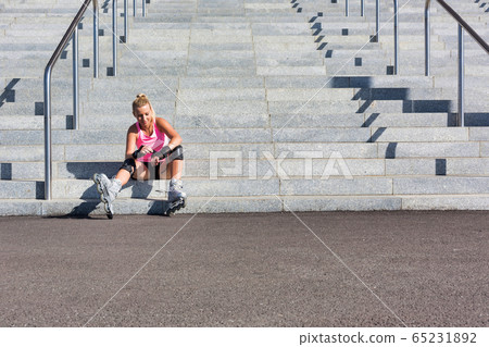 Young attractive woman adjusting safety gear while 65231892
