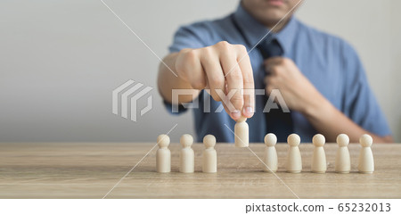 Owner is picking or select wood figure on the wooden roe in human resource management concepts Teamwork.Success Leadership,Business Progress and Competition on wood table and copy space Owner is picking or select wood figure on the wooden roe in human resource management concepts Teamwork.Success Leadership,Business Progress and Competition on wood table and copy space 65232013