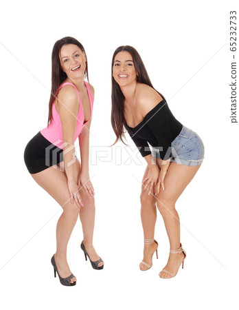 Two beautiful women standing in shorts in the Two beautiful women standing in shorts in the 65232733