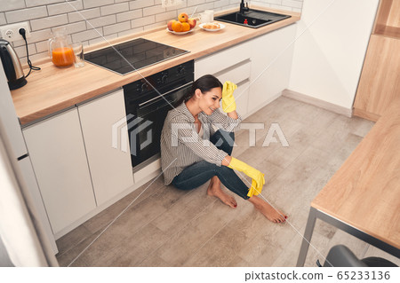 Tired young woman being deep in thoughts 65233136