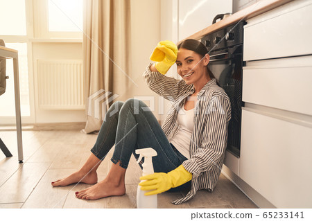 Pleased young female looking straight at camera Pleased young female looking straight at camera 65233141