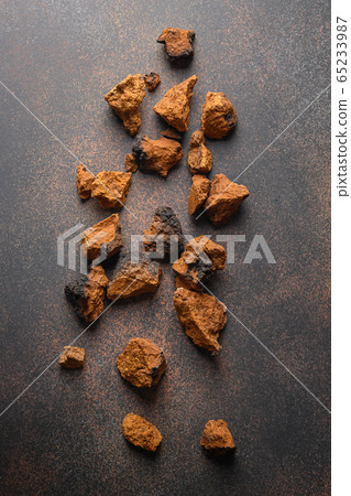 Chaga birch edible Mushrooms on brown. Trendy 65233987