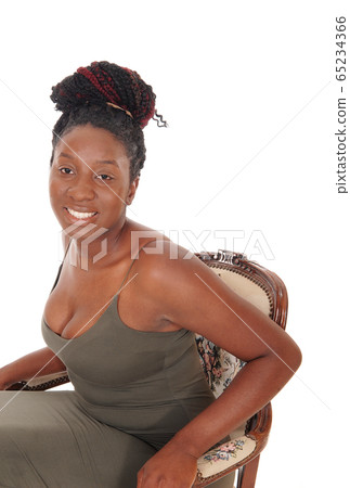 Lovely black female sitting in an old chair Lovely black female sitting in an old chair 65234366
