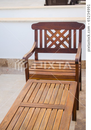 Cozy summer cafe. Wooden tables and chairs on outdoor terrace. Empty street cafe or restaurant. Cozy summer cafe. Wooden tables and chairs on outdoor terrace. Empty street cafe or restaurant. 65234991