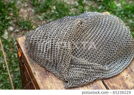 a pile of iron chain mail stacked on a wooden a pile of iron chain mail stacked on a wooden 65236229