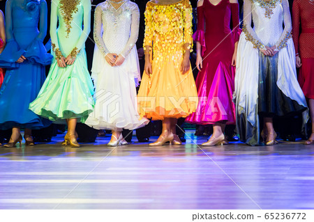 woman in ballroom dresses lined up in a row 65236772